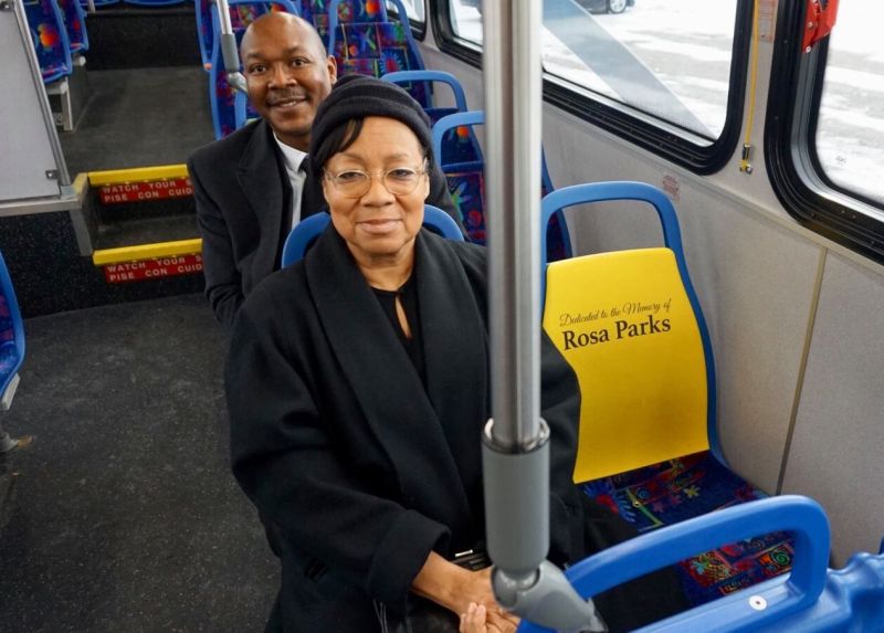 Two passengers riding a bus