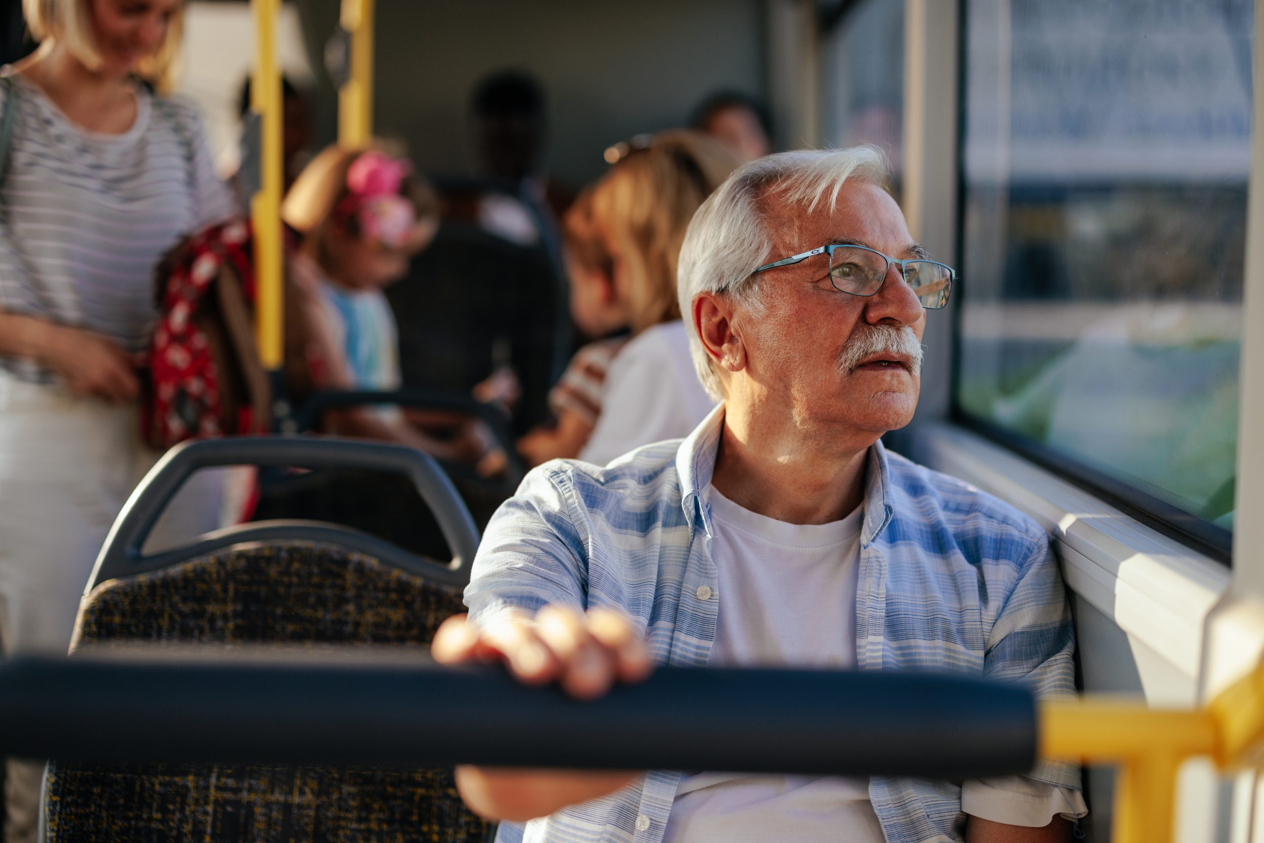 Elderly man riding a bus