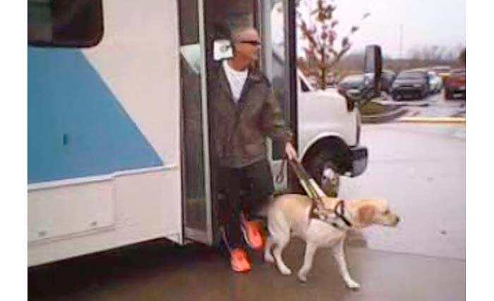 Man getting off the bus with his dog